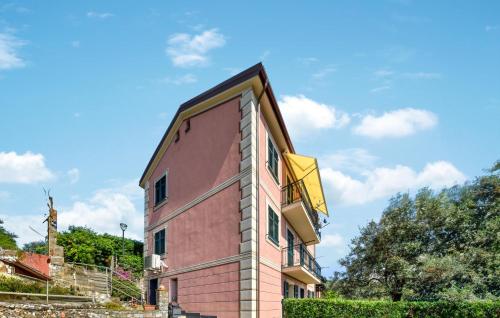 a pink building with a balcony on the side of it at Amazing Apartment In Recco With Kitchen in Recco