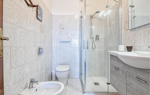 a bathroom with a toilet and a sink and a shower at Amazing Apartment In Recco With Kitchen in Recco