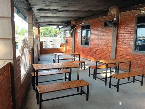 a row of benches sitting in a building at Roomstay By Abe Cottage in Kuala Besut
