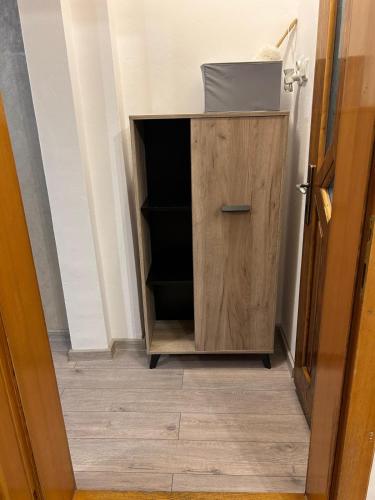 a wooden cabinet with a sink in a hallway at Casa Lotus in Lugoj