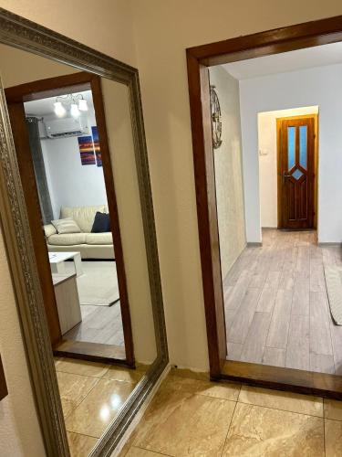 a mirror in a room with a living room at Casa Lotus in Lugoj