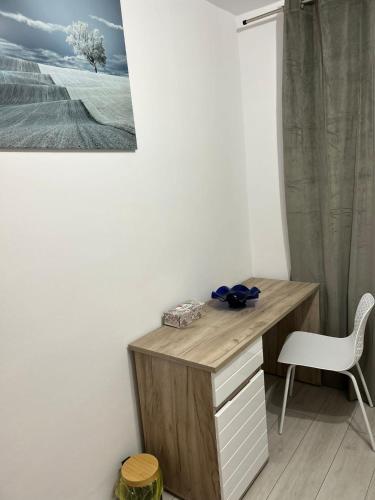 a desk with a chair and a picture on the wall at Casa Lotus in Lugoj
