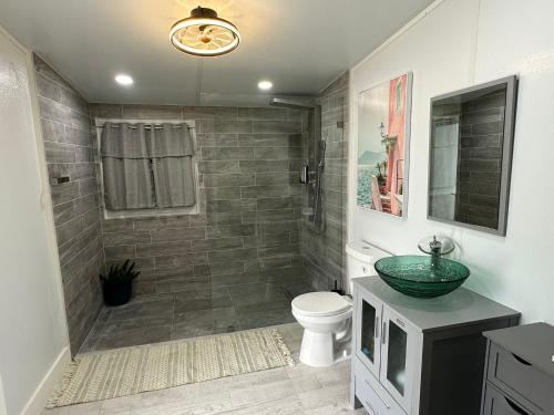 a bathroom with a shower with a toilet and a sink at Pool House Resort heated swimming pool family getaway in Cutler Bay
