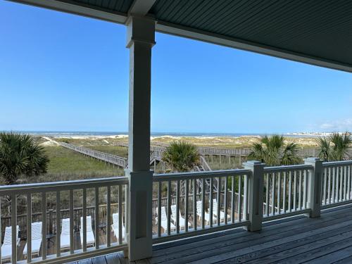 a view of the beach from the porch at Most Requested 16 Br Oceanfront Home in Holden Beach in Holden Beach