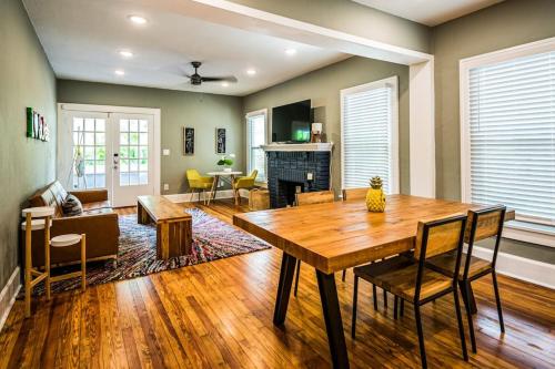 a dining room and living room with a wooden table at C'est La Vie - make memories at our cozy bungalow in St. Petersburg