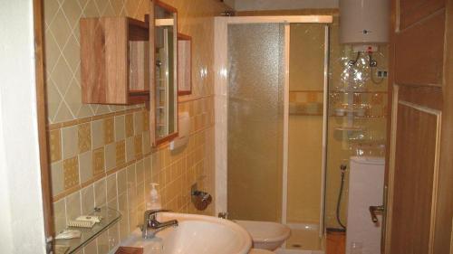 a bathroom with a sink and a toilet and a shower at B&B A Casa Di Andrea in Mantova