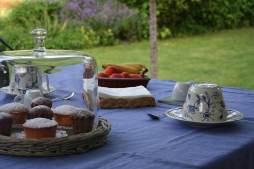 una mesa con un mantel azul con un plato de comida en Le Cerisier, en Mareil-Marly