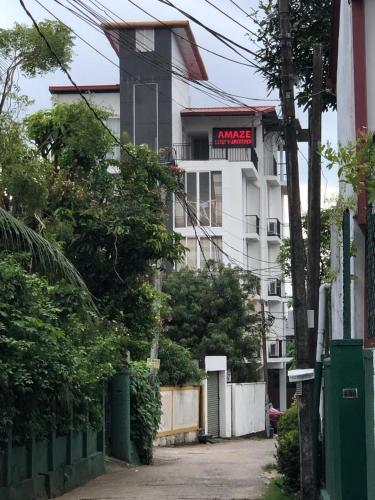 a white building with a sign on it at Amaze Residence luxury 2bedroom apartment 2 in Boralesgamuwa