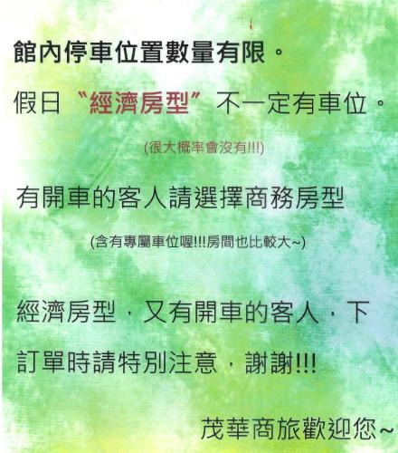 a sign with chinese writing on a green background at Mao Hua Motel in Dajia