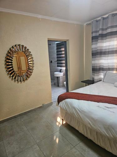 a bedroom with a bed and a mirror on the wall at Buffalo guest lodge in Bushbuckridge