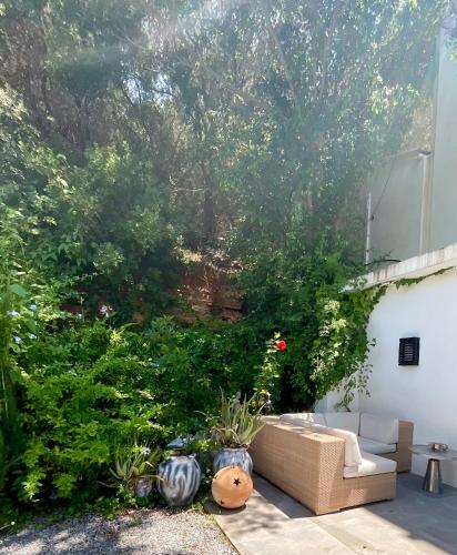 a patio with a couch and some bushes and trees at Marbella Boutique Art suites in Marbella