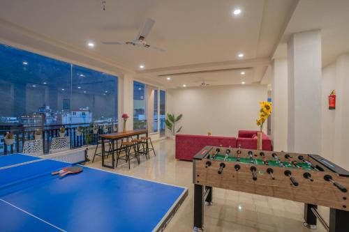 a living room with a ping pong table and a table at Perfectstayz Value Alpine Near Laxman Jhula in Rishīkesh
