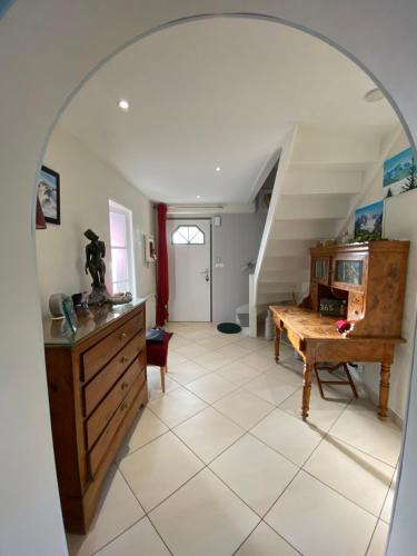an archway in a room with a table and stairs at Emeraude in Gex