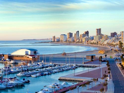 a harbor with boats in the water and a beach at Vivienda en El Campello playa in El Campello