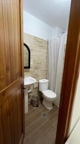 a bathroom with a toilet and a sink at Denis GuestHouse 1930 in Gjirokastër