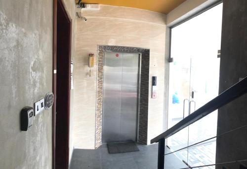 a hallway with a metal elevator in a building at Amaze Residence luxury 2 bedroom apartment 6 in Boralesgamuwa
