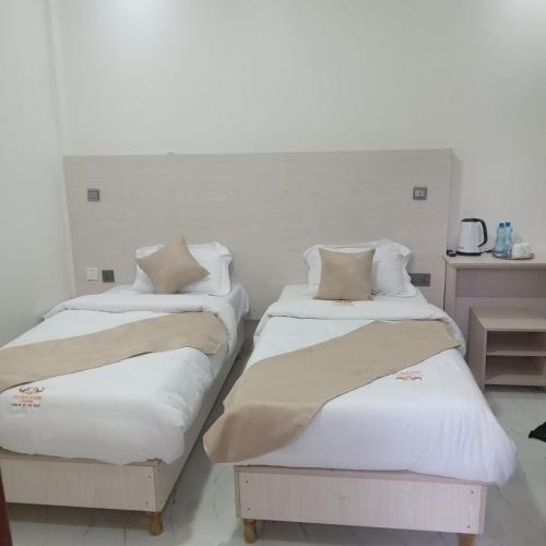two beds sitting next to each other in a room at Ole Sidai Riverine Gardens in Karatina