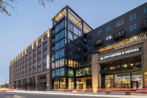 a building with a lot of windows on a street at 1 Bedroom apt suite Wifi fitness room Deep Ellum-FIFA WORLD CUP 2026 in Dallas