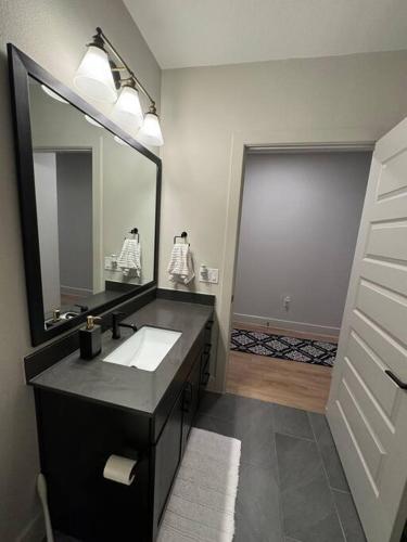 a bathroom with a sink and a large mirror at 1 Bedroom apt suite Wifi fitness room Deep Ellum-FIFA WORLD CUP 2026 in Dallas