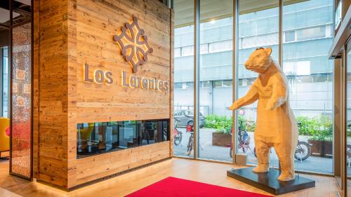 a statue of a bear standing in front of a store at Los Lorentes Apartments Bern City in Bern