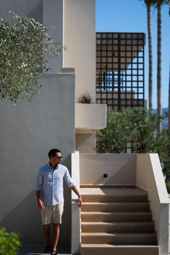 a man standing in front of a staircase at The Ritual, A Wellness Retreat in Lampi