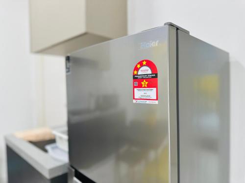 a refrigerator with a sign on it in a kitchen at The Sun 1 or 3BR Bayan Lepas 4 to 10 pax WL in Bayan Lepas