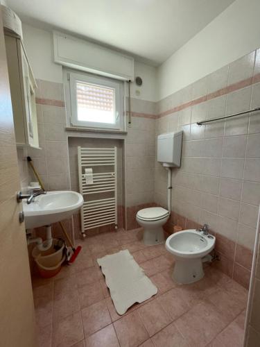 a bathroom with a toilet and a sink at Residence Cascata Varone in Riva del Garda