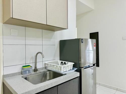 a kitchen with a sink and a refrigerator at The Sun 1 or 3BR Bayan Lepas 4 to 10 pax WL in Bayan Lepas
