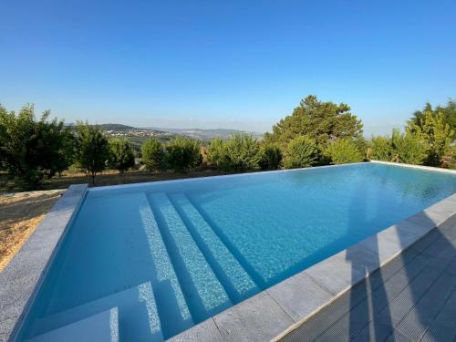 a swimming pool in a villa with a view at Quinta da Eira Douro Valley in Fermentões