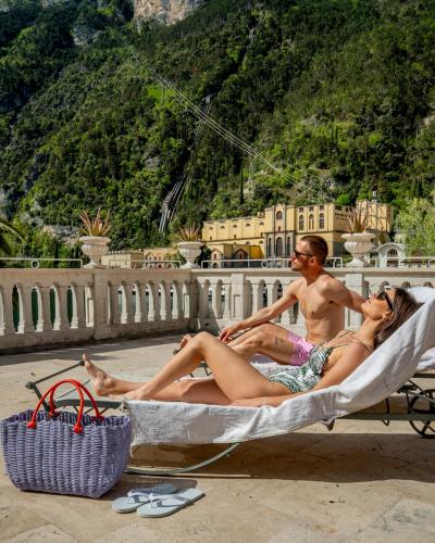 two people sitting in a hammock on the beach at Bellavista Lakefront in Riva del Garda