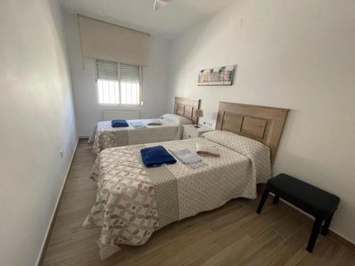 a room with two beds and a table at VILLA VAQUERO - Gandía in Gandía