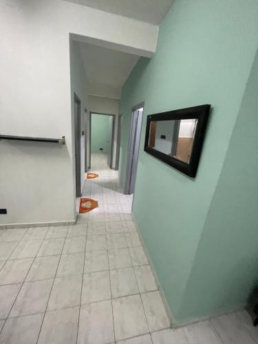 an empty hallway with a mirror on a wall at Blissful Breeze 4 ROOMS & NETFLIX by EZYROOM MELAKA in Ayer Keroh