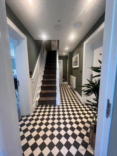 a hallway with a black and white checkered floor at Krugers Guest House in Dunquin