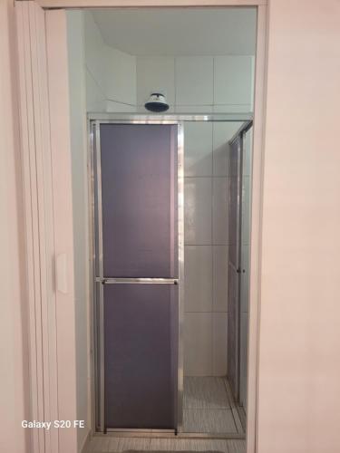 a glass door of a shower in a bathroom at Quarto Disponível em Sobrado in Sao Paulo