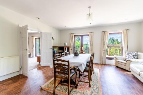 a dining room with a table and a couch at The House @ Sitwell Arms Hotel in Renishaw
