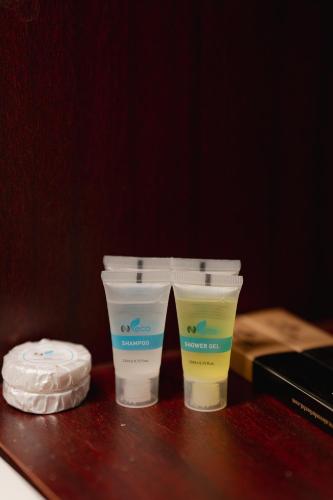 two plastic cups sitting on top of a table at Royal Residence Dhaka in Dhaka