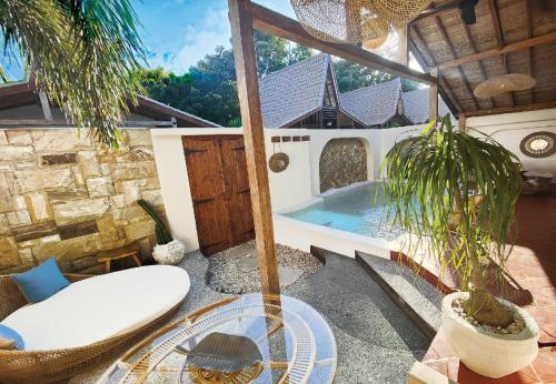 a patio with a plunge pool in a house at Kaleydo Villas in Gili Trawangan