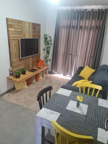 a living room with a couch and a table at AP CENTRO Campinas in Campinas
