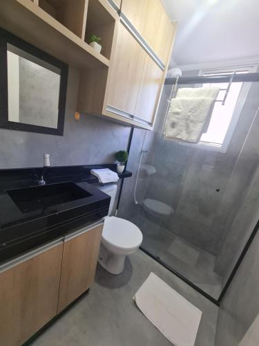 a bathroom with a shower and a toilet and a sink at AP CENTRO Campinas in Campinas