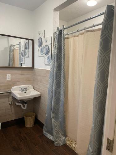 a bathroom with a shower curtain and a sink at Radiant Retreat #7 in Daytona Beach