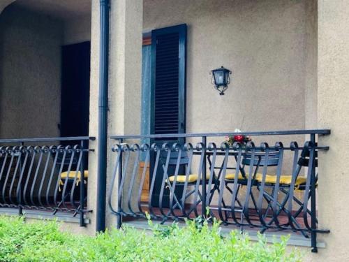 a balcony with a table and chairs on a building at Villetta la Magnolia in Vicchio