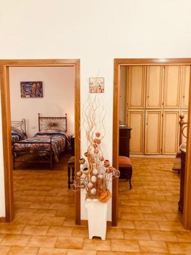 a room with a mirror and a bedroom with a bed at Villetta la Magnolia in Vicchio
