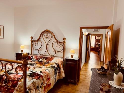 a bedroom with a large bed and a mirror at Villetta la Magnolia in Vicchio