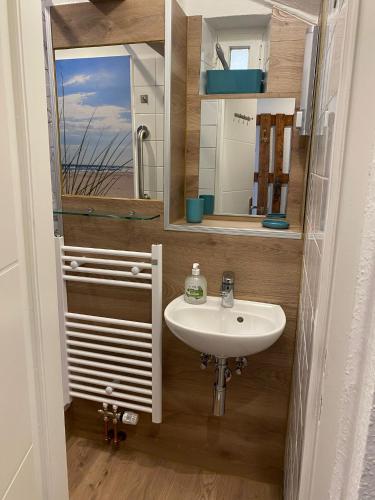 a bathroom with a sink and a mirror at Ferienwohnung Mia in Lübeck