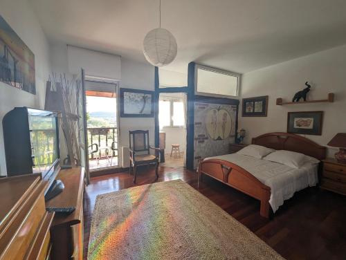 a bedroom with a bed and a balcony at Casa Rural Bilbao Caserio Gondra Alquiler Habitaciones in Mungia