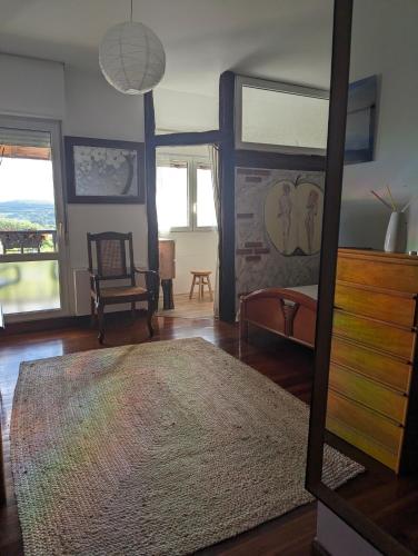 a living room with a mirror and a dresser at Casa Rural Bilbao Caserio Gondra Alquiler Habitaciones in Mungia