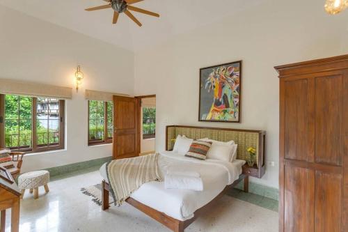 a bedroom with a bed and a ceiling fan at Casa Dolce Vita 4 bed villa with a pvt pool in North Goa in Bardez
