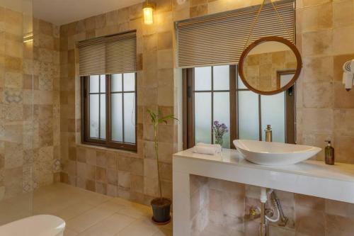 a bathroom with a sink and a mirror at Casa Dolce Vita 4 bed villa with a pvt pool in North Goa in Bardez