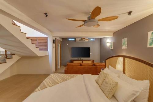 a bedroom with a bed and a ceiling fan at Casa Dolce Vita 4 bed villa with a pvt pool in North Goa in Bardez