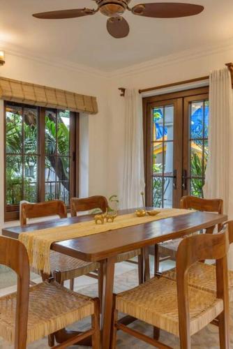 a dining room with a wooden table and chairs at Casa Dolce Vita 4 bed villa with a pvt pool in North Goa in Bardez